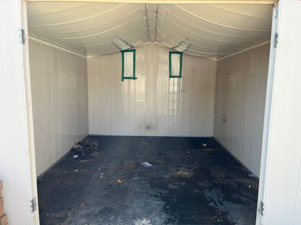 The same shed emptied down to its bare floor and walls