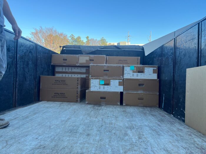 A container loaded with boxed goods on a commercial site