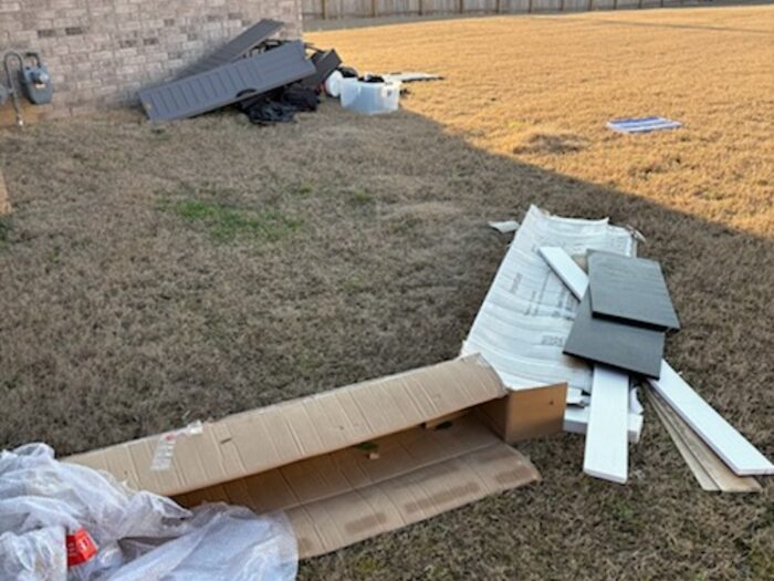 Packaging, trim offcuts and building waste left on a back lawn